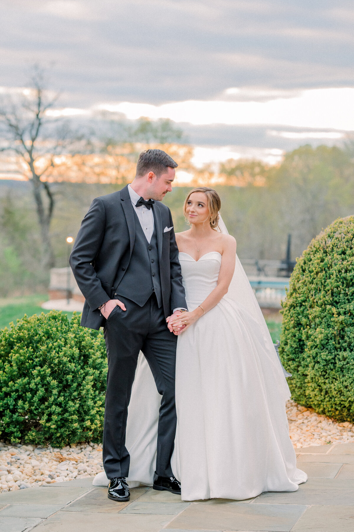 Bride and groom during portraits during golden hour sunset at the estate at river run