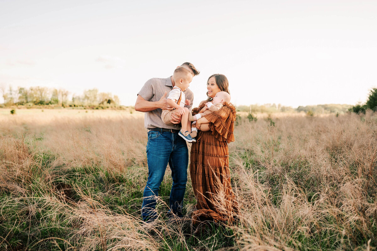 family smiling at each other enjoying Springfield MO family photography