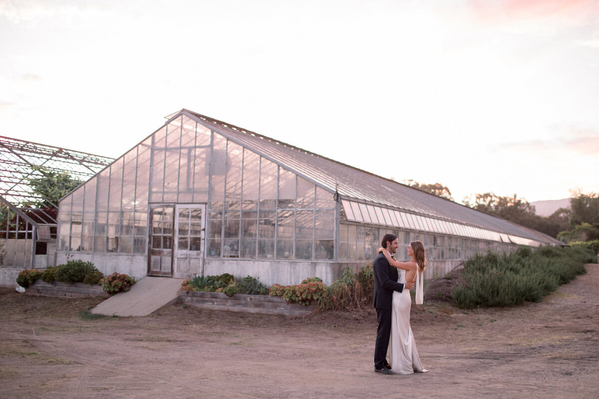 wide shot of greenhouse at dos pueblos orchid farm  with couple in front