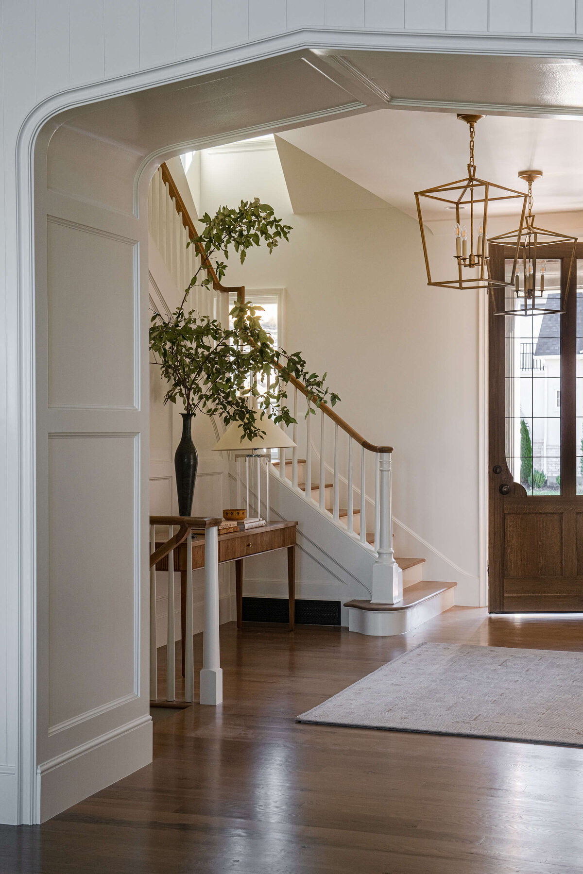 dutch-tudor-entry-hall-with-staircase-and-wood-door