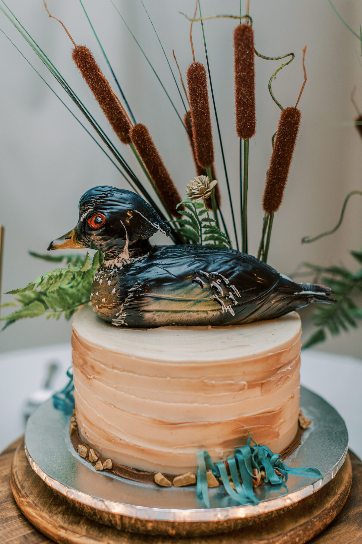 A duck sits on top of the cake.