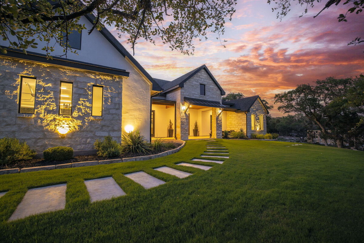 concrete pavers in grass leading to entrance of home