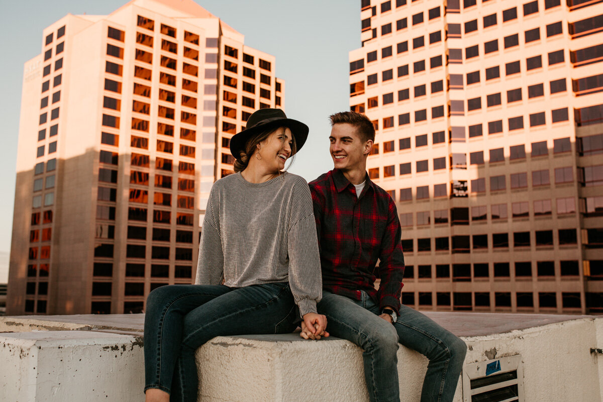Couple sitting on a rooftop downtown Albuquerque
