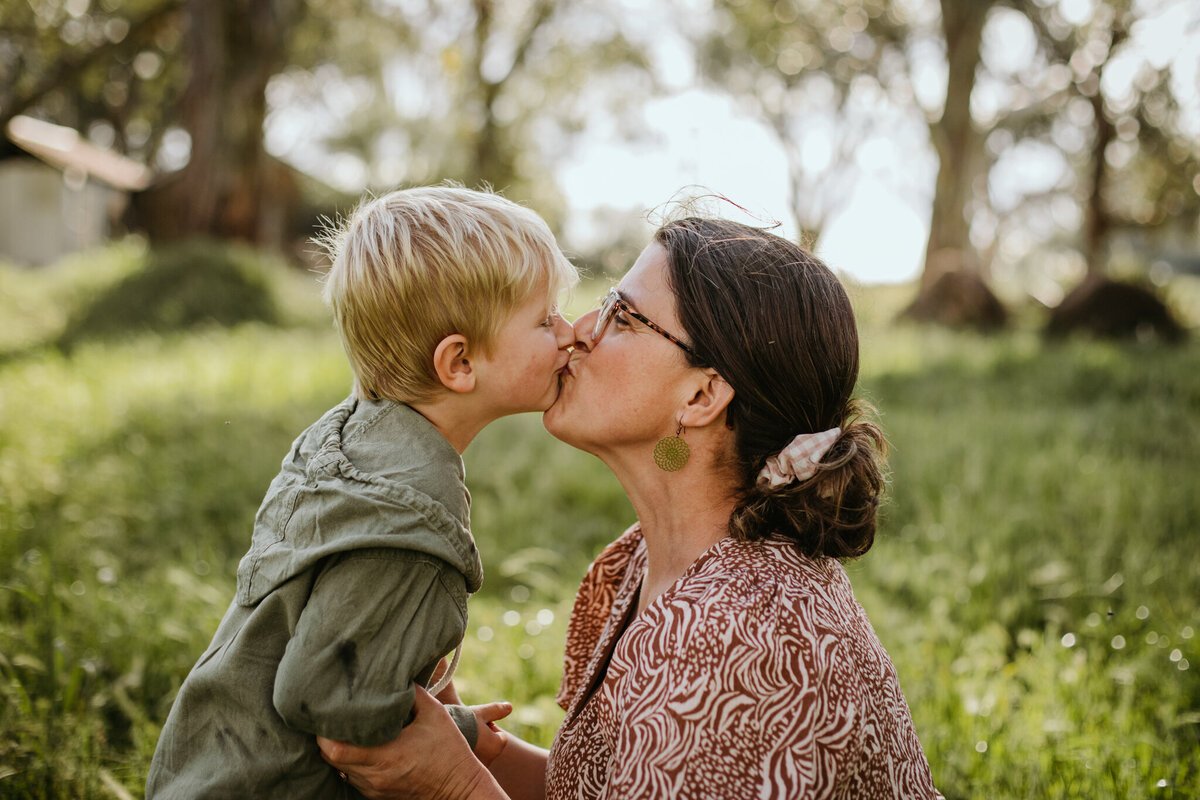 A cute kiss shared between mom and son.