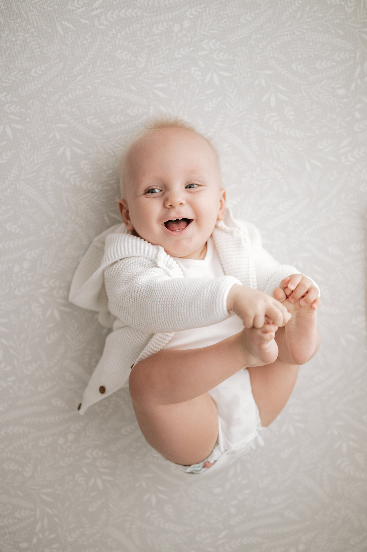 Artistic baby photography of a child laughing