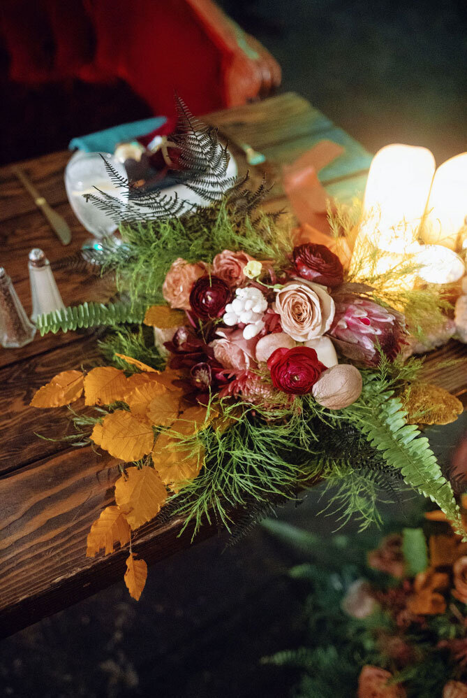 Beautiful floral table scape with fall colors and candles on a table