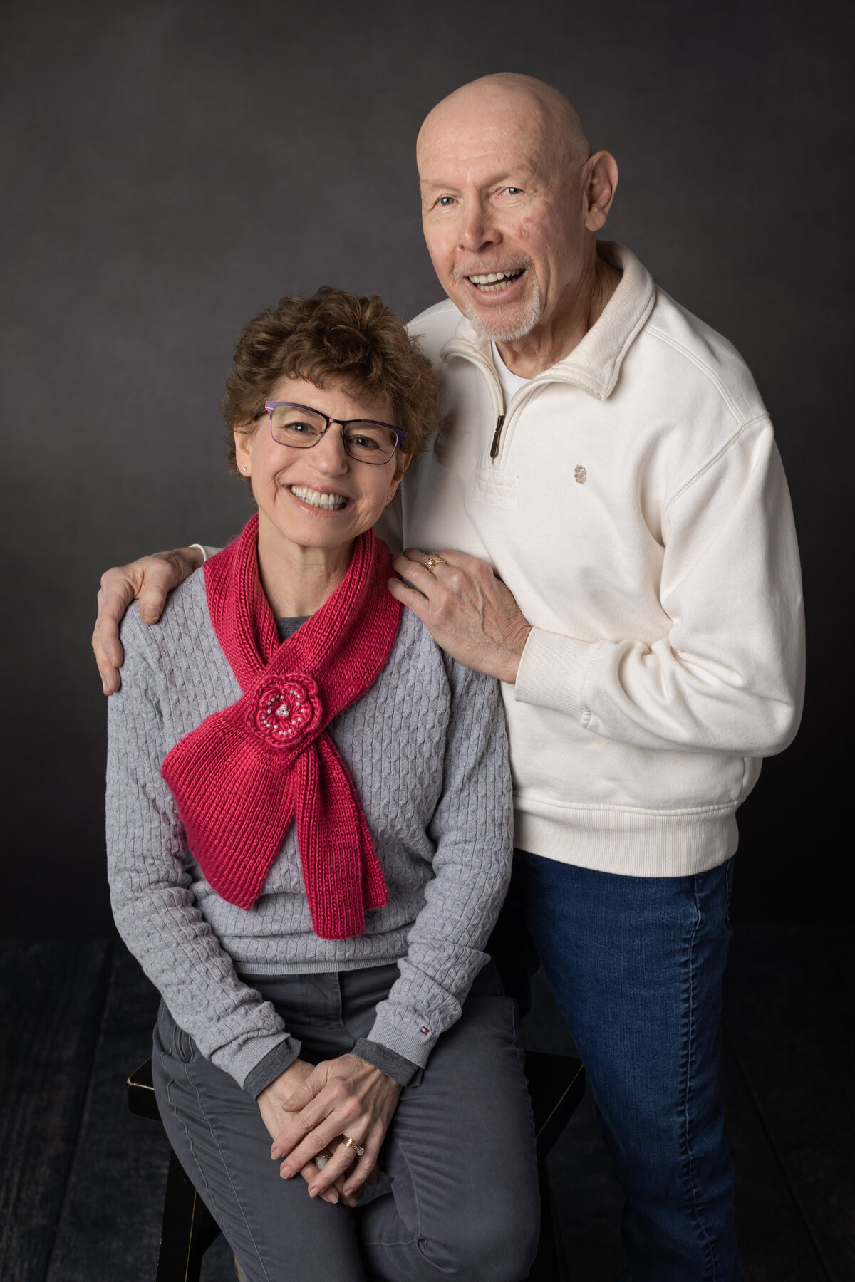 husband and wife posing for studio portraits