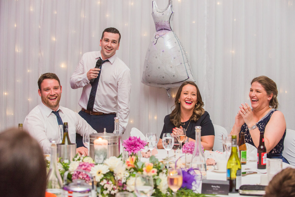 Groomsman giving speech at gay wedding