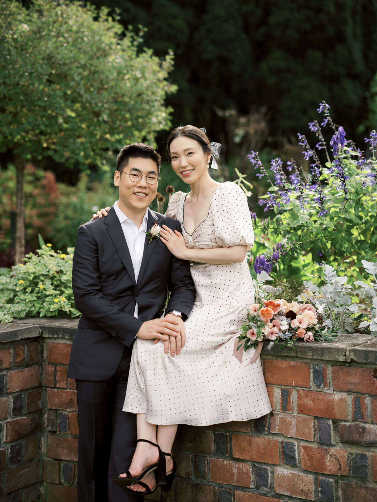 The engaged couple amidst a lovely garden with beautiful flowers at Planting Fields Arboretum, NY. Image by Jenny Fu Studio