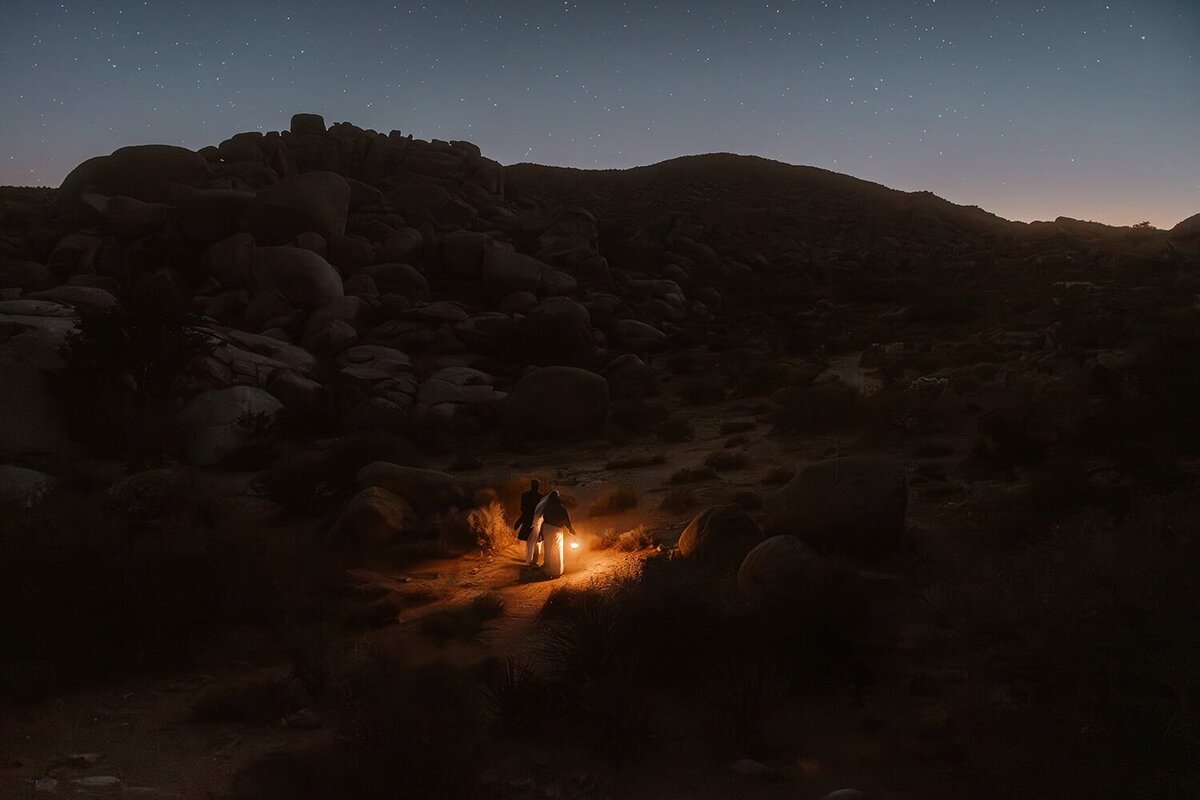Silhouettes of a couple leaning toward each other with a crescent moon and stars filling the night sky behind them, creating a dreamy double exposure effect.
