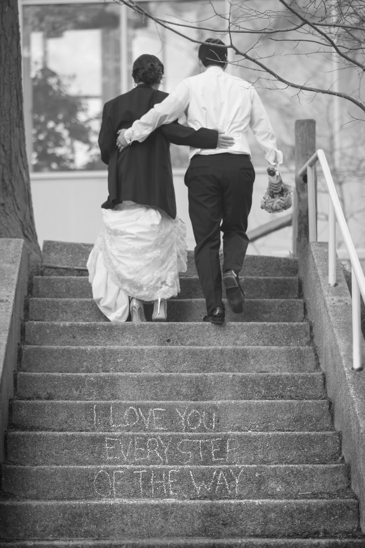 A creative message is written on the stairs for a bride and groom.