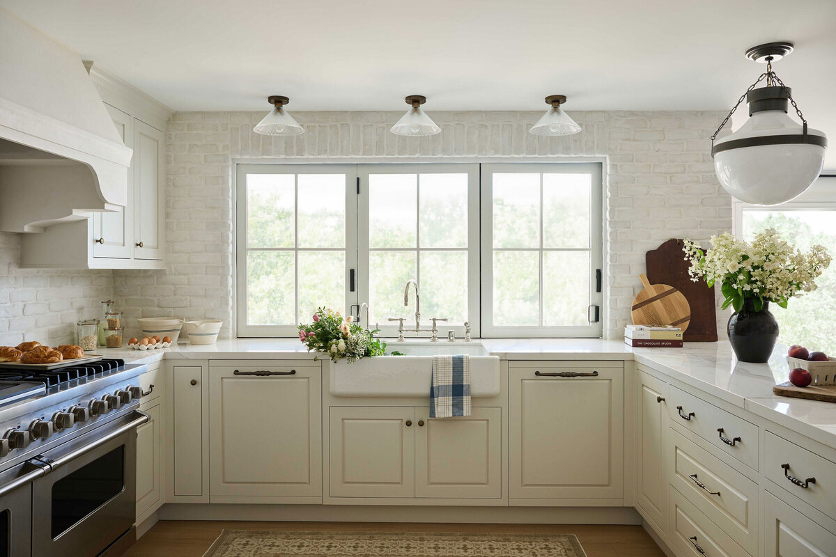 Coastal farmhouse kitchen with marble countertops and natural materials in Orange County