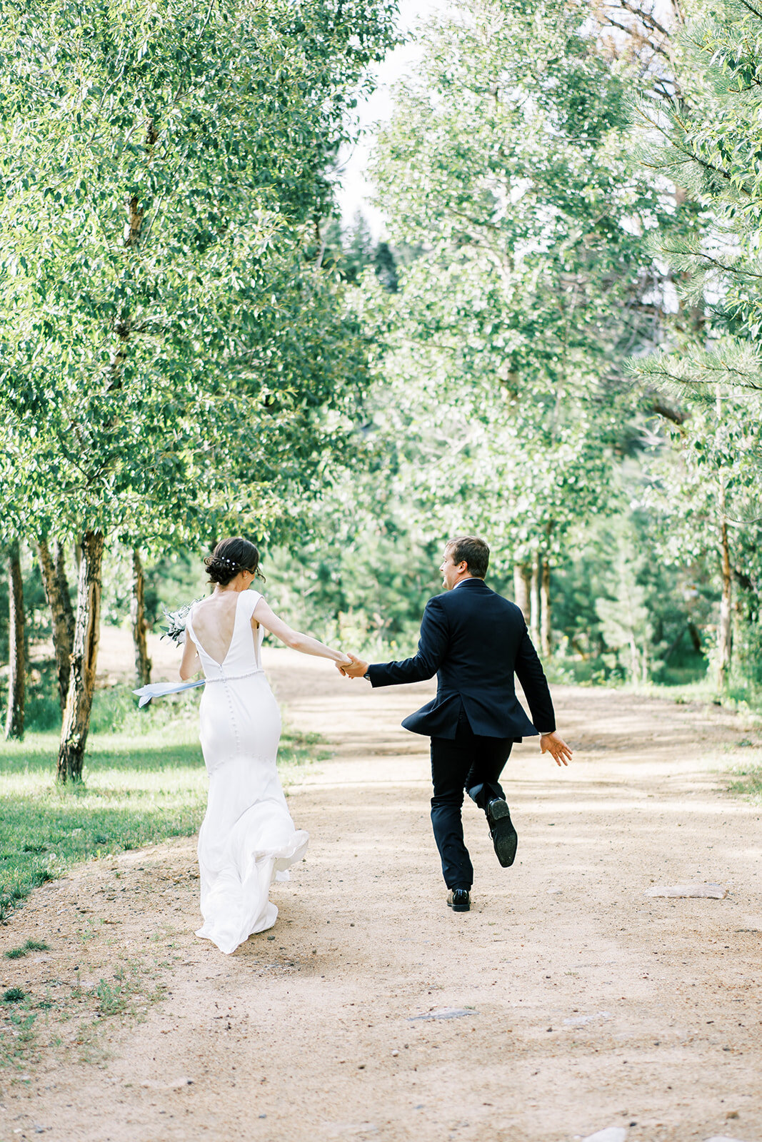 Bride and groom skip after their wedding ceremony at the venue the Landing in Estes Park.