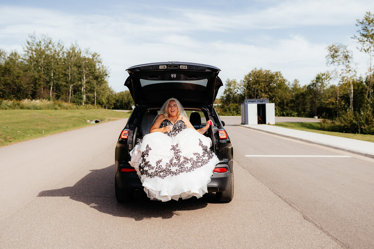 bride-rides-in-the-back-of-a-car-with-poofy-dress
