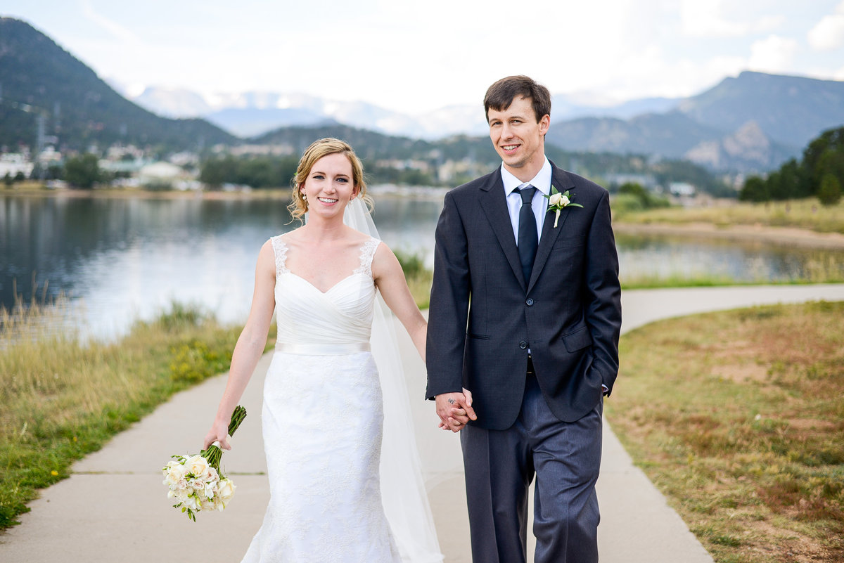 bride and groom near large lake