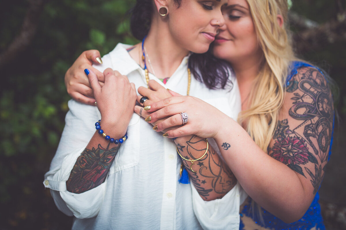 Two brides embrace and smile during their Vancouver Island photo session.