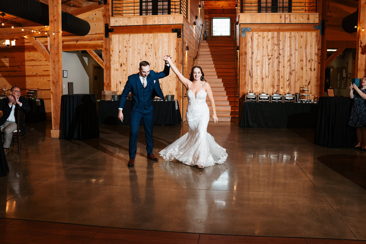 Elegant reception setup with candles, florals, and wooden tables