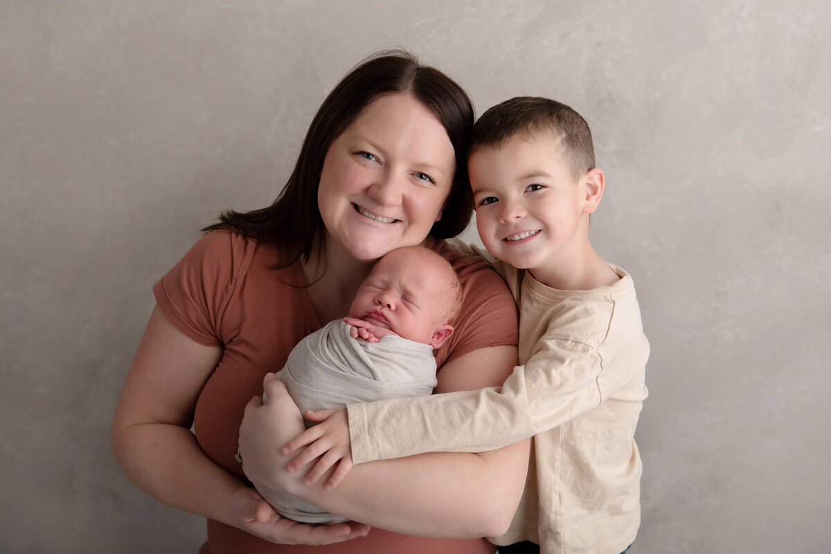 Mom with her older son and newborn baby boy for their Burlington, Ontario newborn photography session.