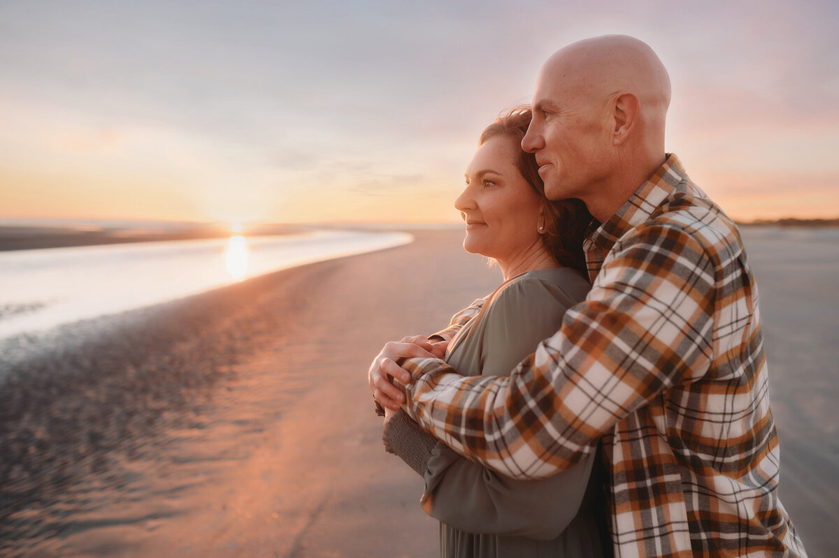 Husband embraces his wife during Family Photos on Kiawah.