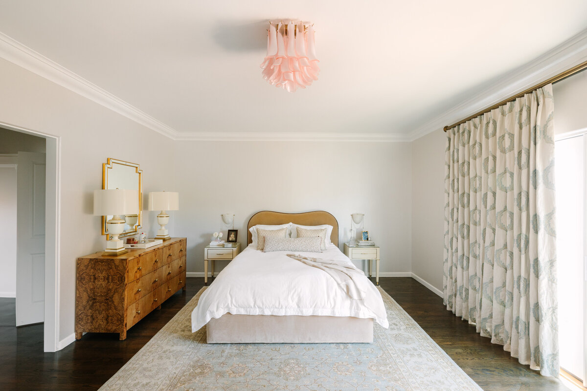 Primary bedroom with burled wood dresser, 