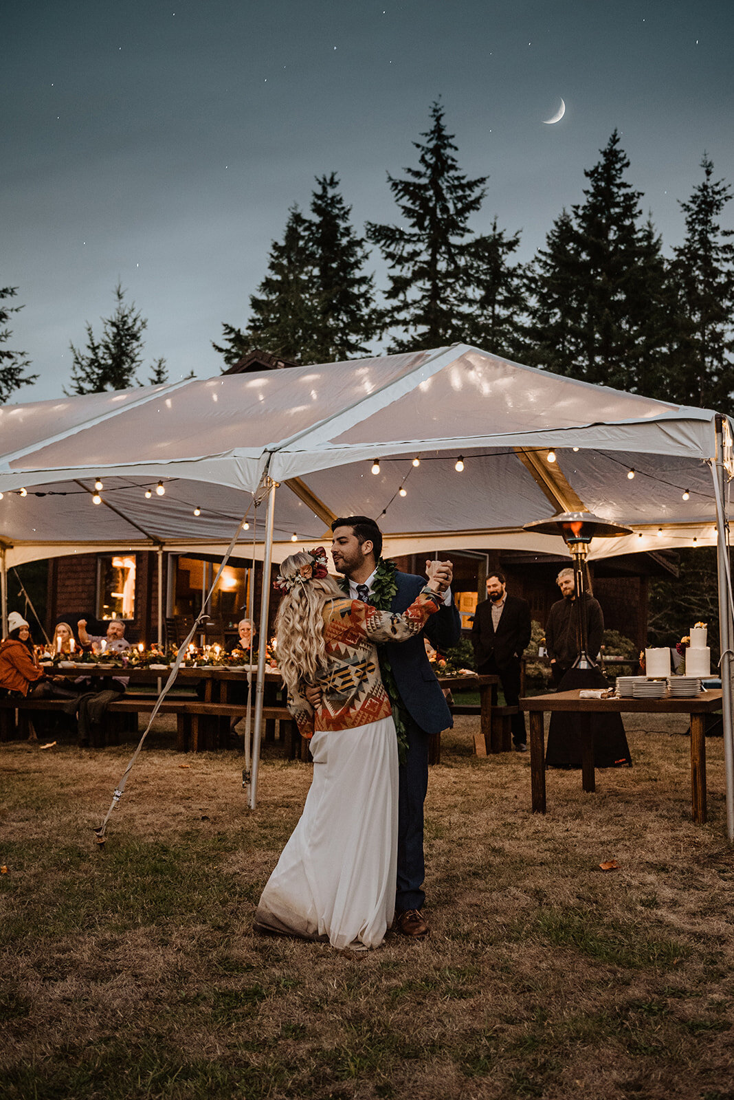 Bride & groom dancing at twilight with their clear-top tent lit up in the background!