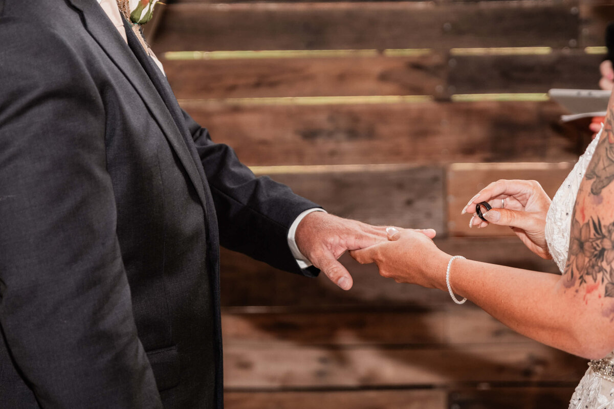 A wedding ceremony unfolds in a rustic barn at the mill, surrounded by beautiful decorations and an intimate setting. - photo by Jamie Simmons