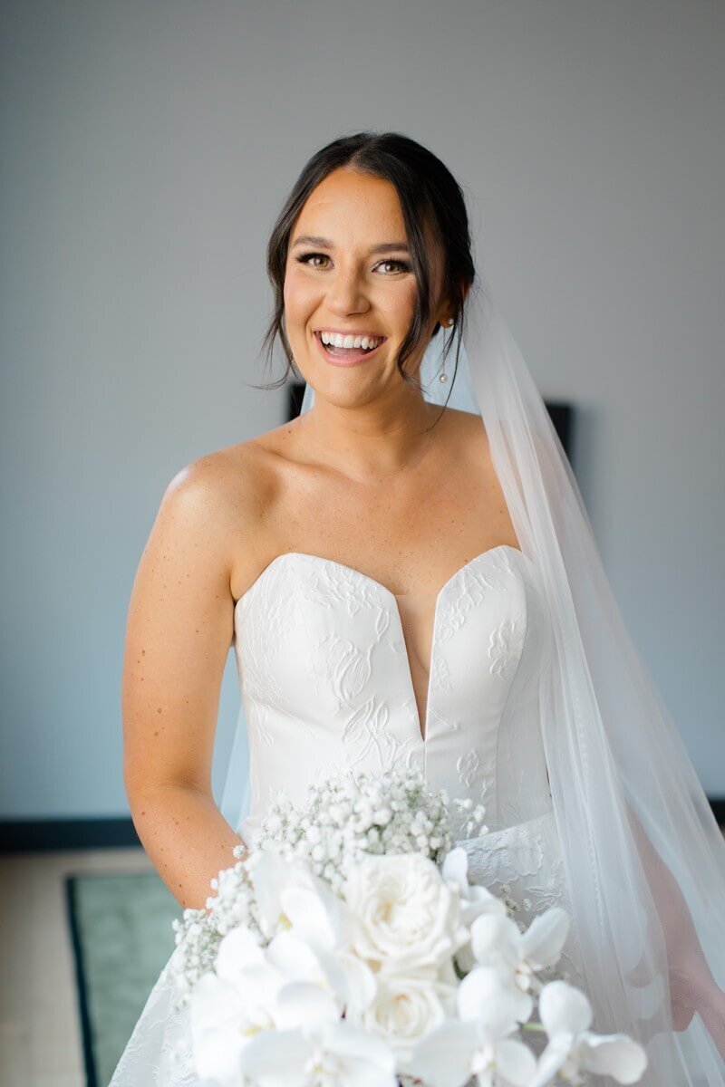 bride holding all white bouquet