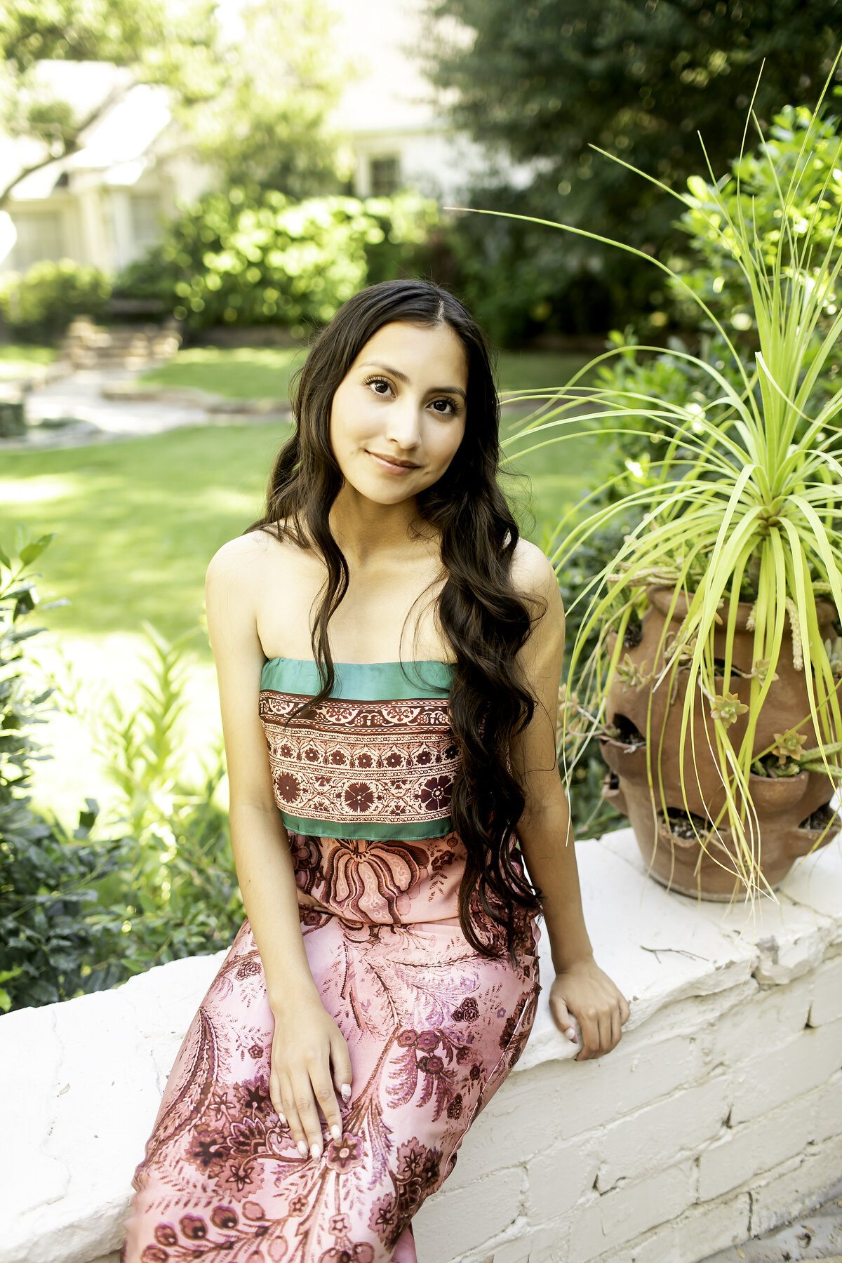 Senior photoshoot in the enchanting Chandor Gardens of Weatherford, TX, where the beauty of nature and the graduate’s excitement come together to create unforgettable memories
