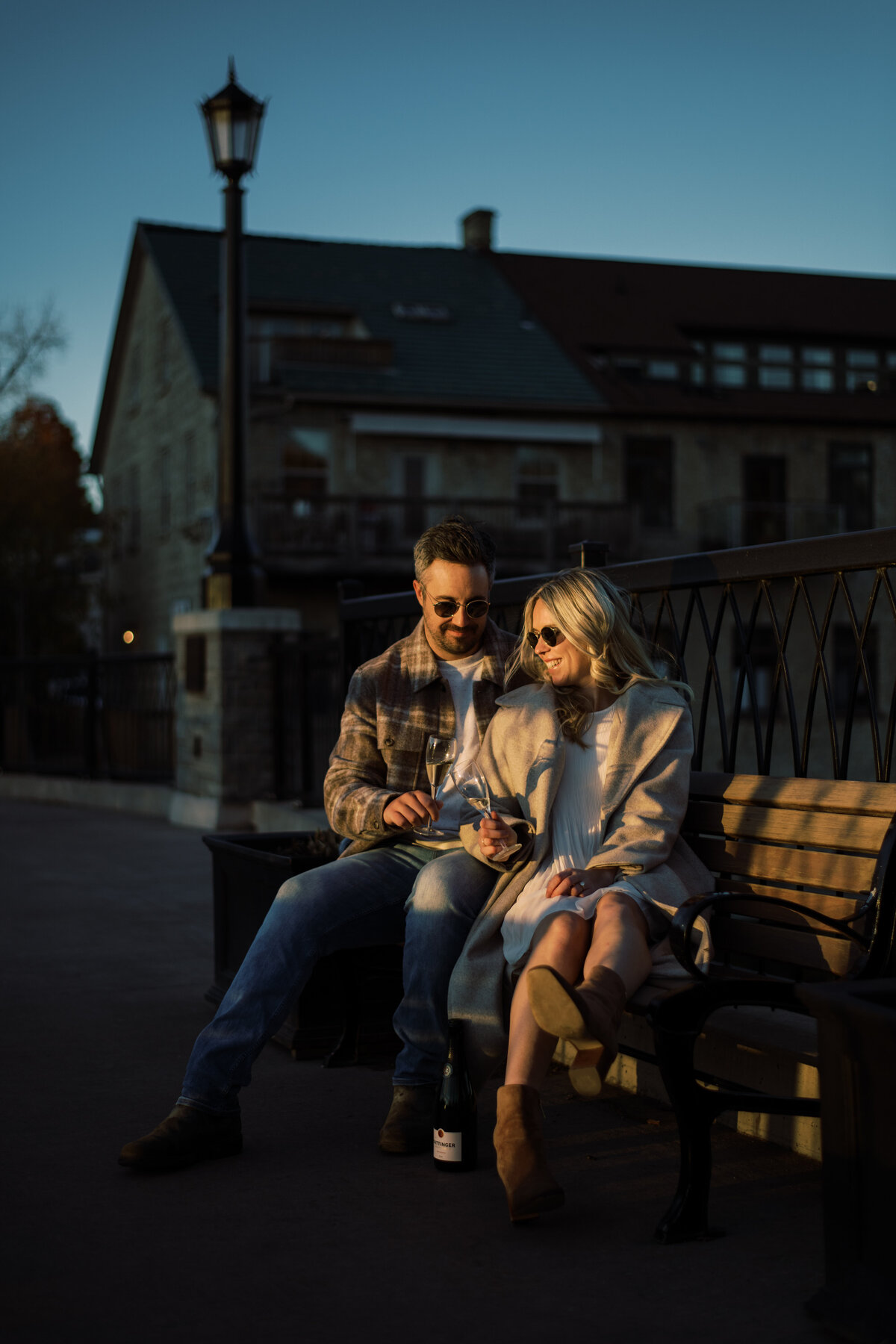 Evening glasses of wine with couple in elora mill ON sitting on bench