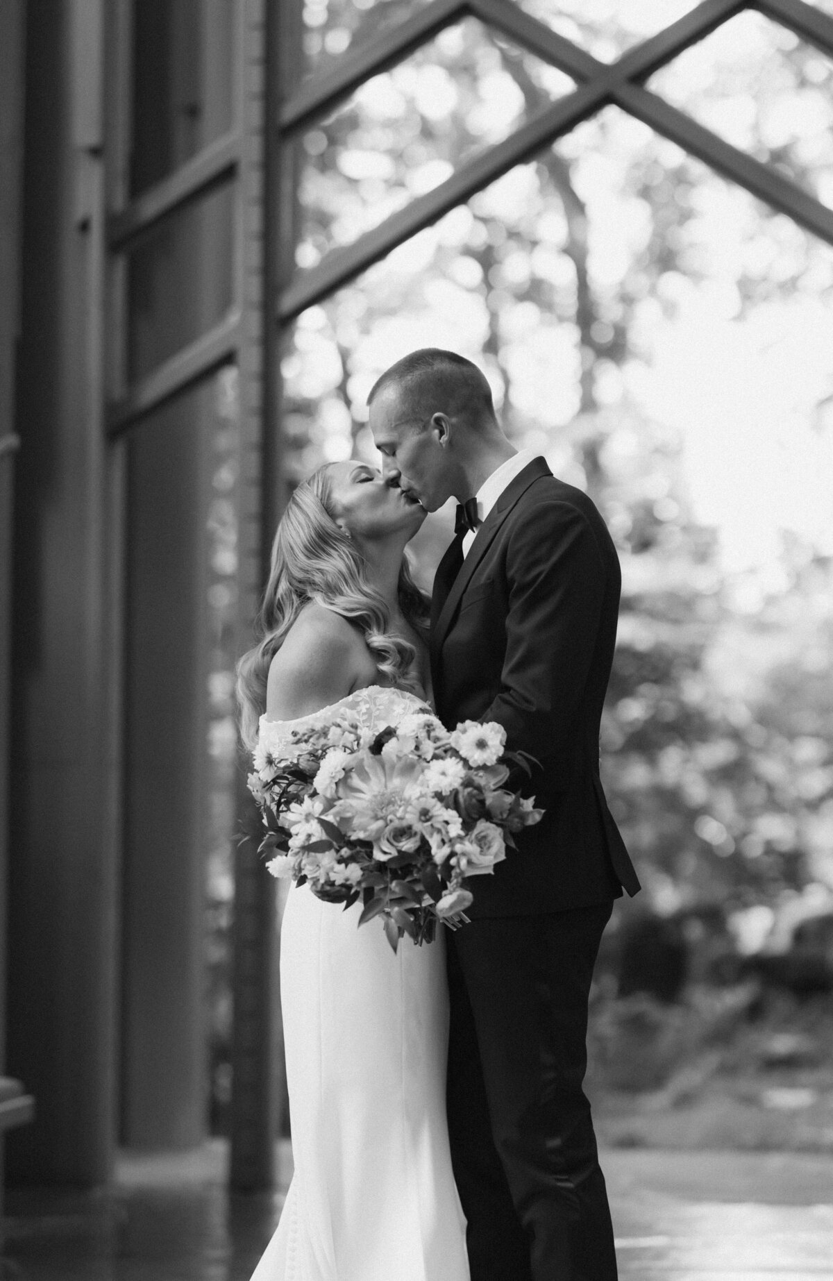 Timeless Black and White Wedding Portrait Kiss at Chapel