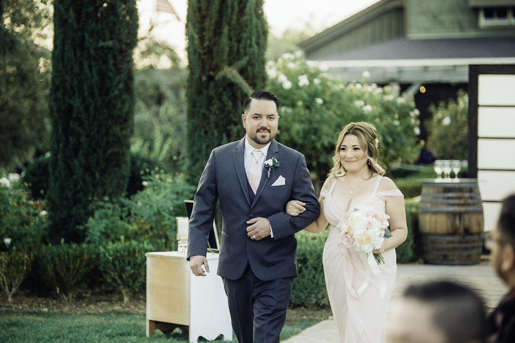 Wedding Photograph Of Groomsman And Bridesmaid Passing The Aisle Los Angeles