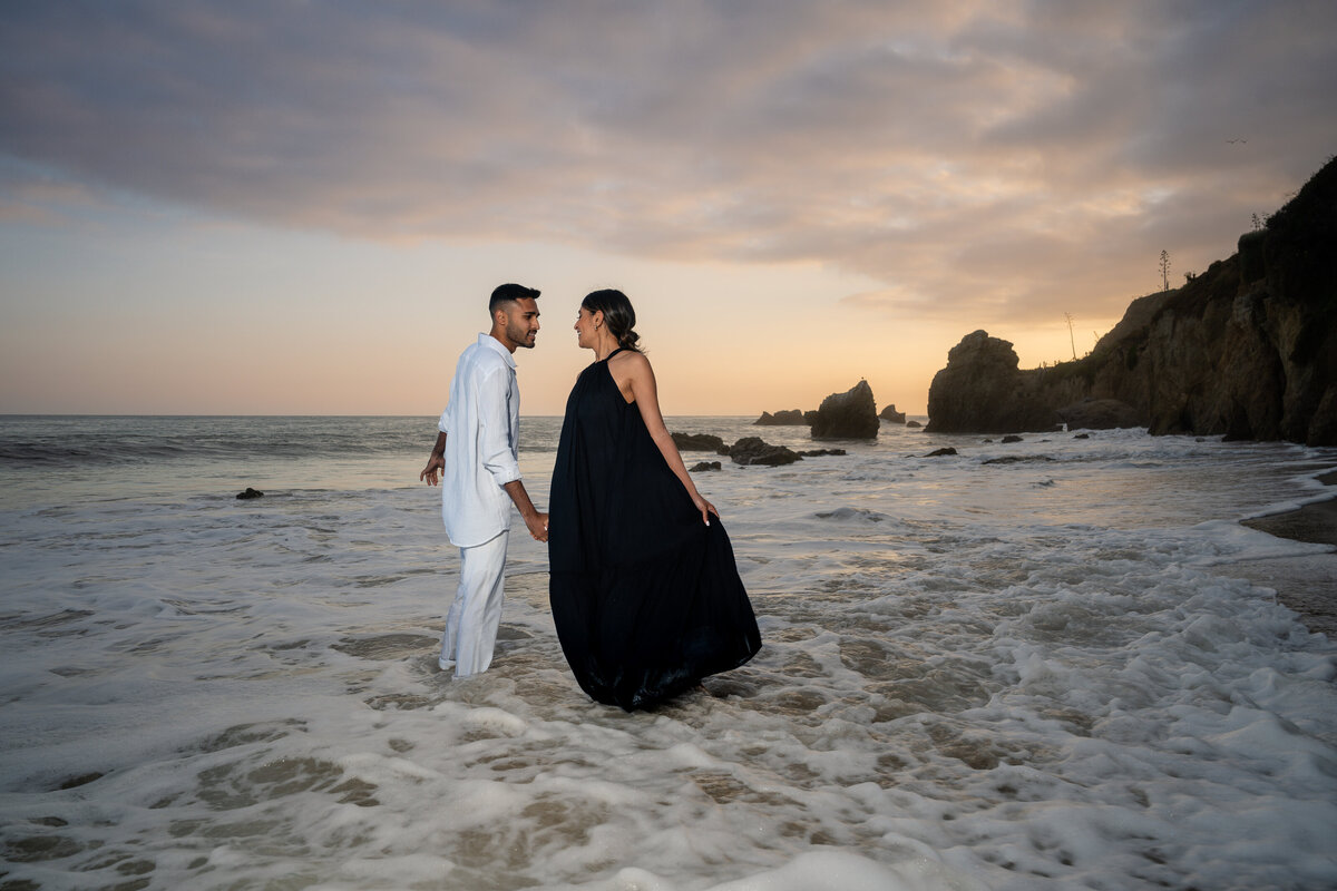Indian couple eloping at El Matador State Beach in Malibu during low-tide sunset and dancing.
