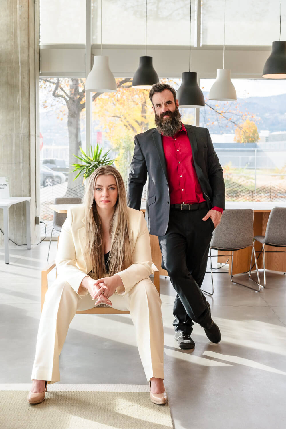 business partners in bold outfits in modern office setting for creative portrait session