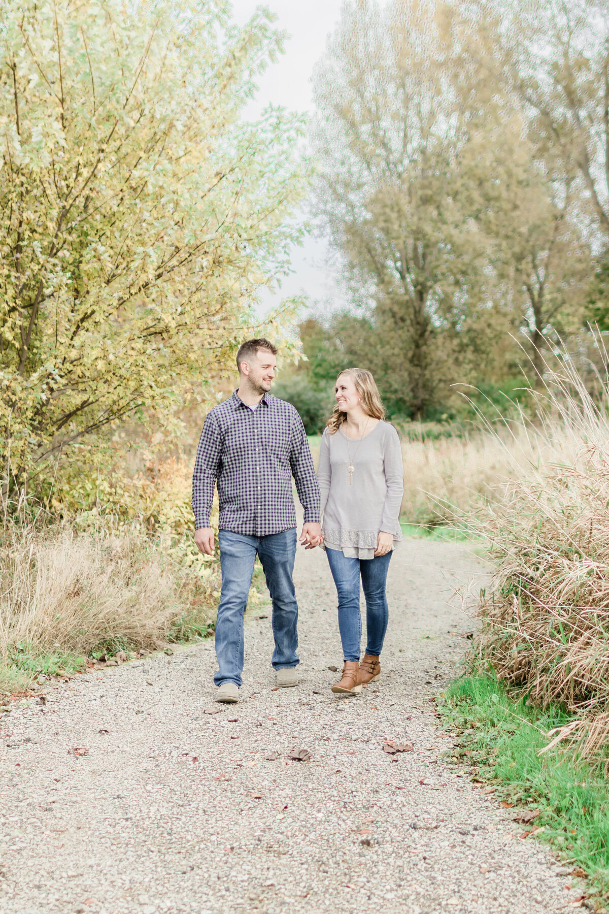 couple holding hands and walking towards the camera