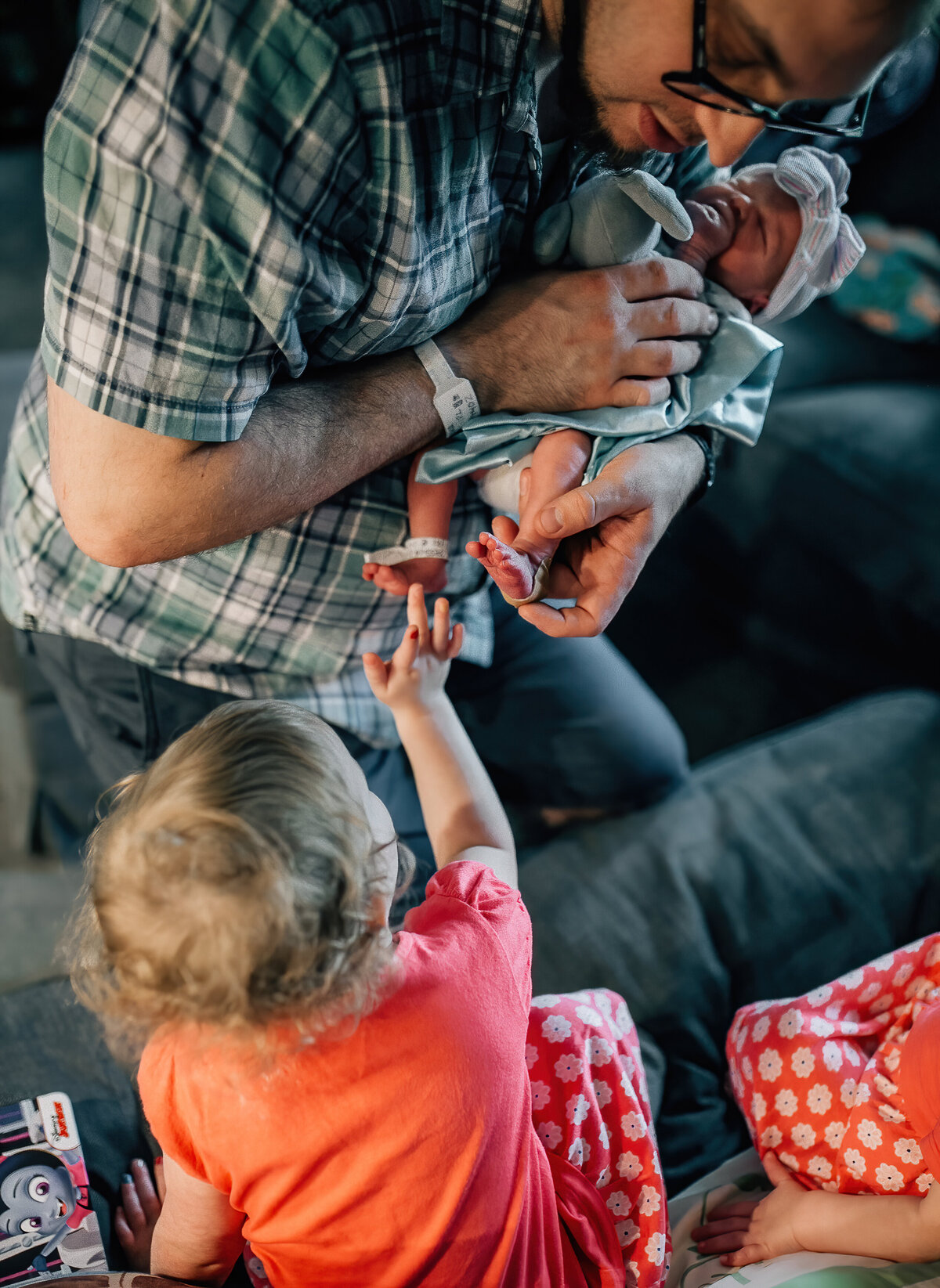 Newborn baby foot being held by dad.