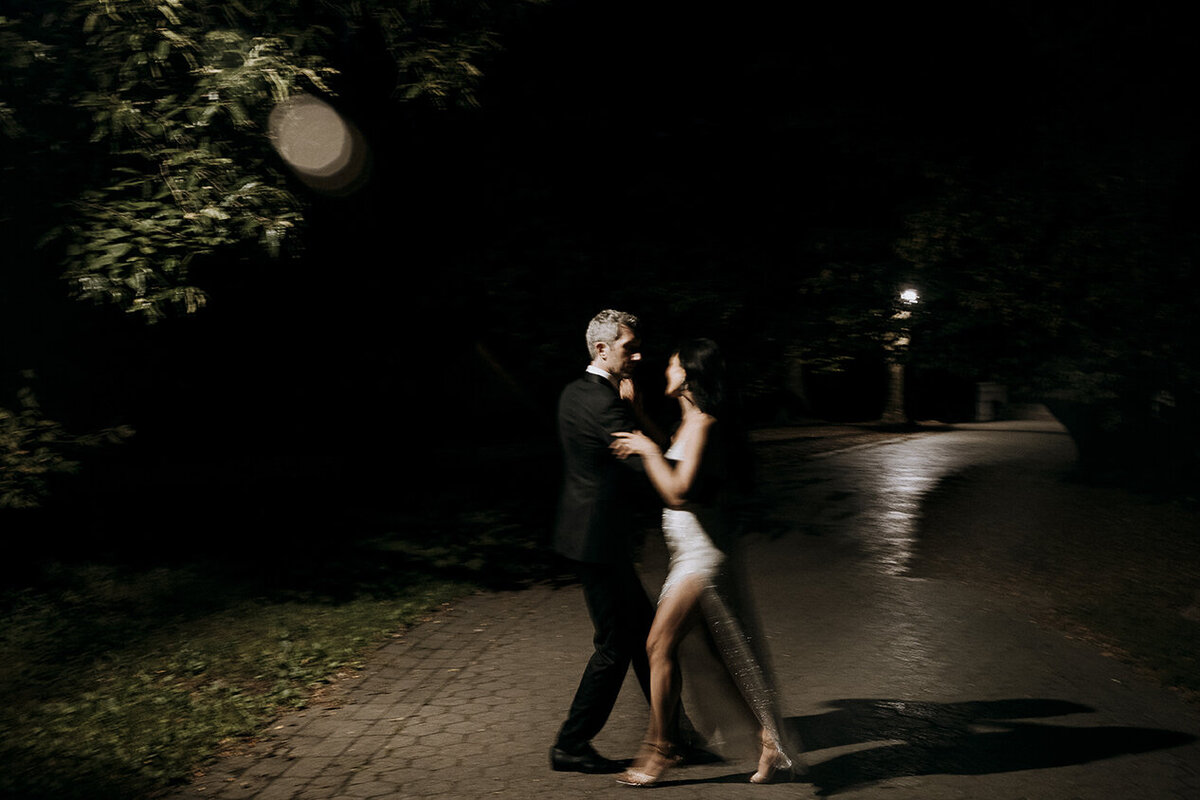 Bride and Groom dance tango at night under a street lamp in Prospect Park near Purslane at the Boathouse in Brooklyn, NY. Photo by Mira Park Photography.