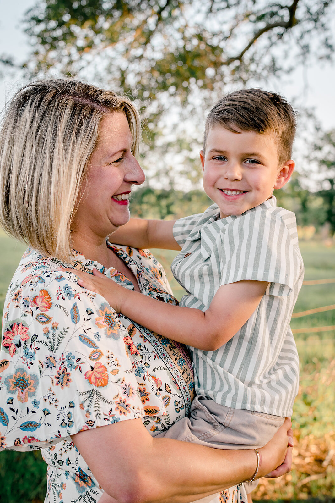 Smiles between mother and son in an outdoor location.