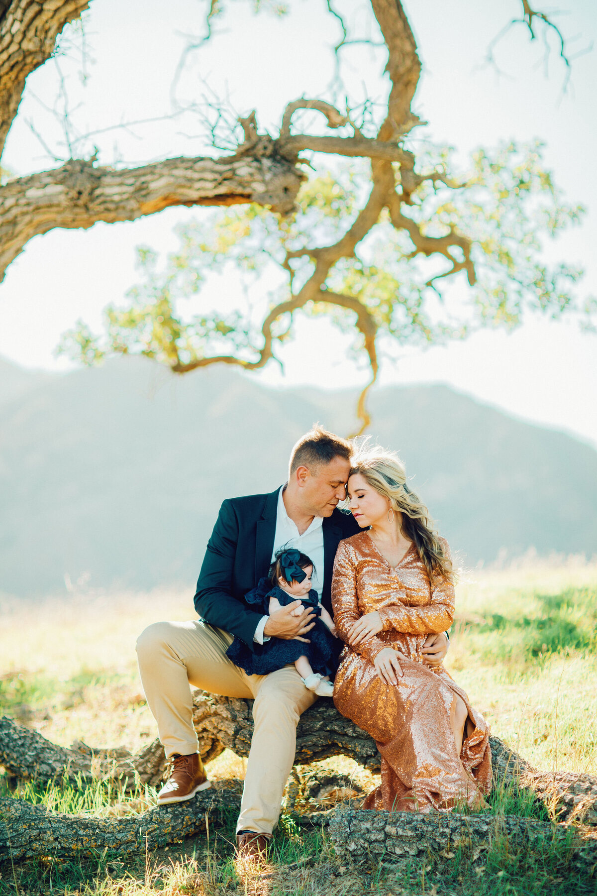 Family Portrait Photo Of Couple Holding Their Baby Under a Tree Los Angeles