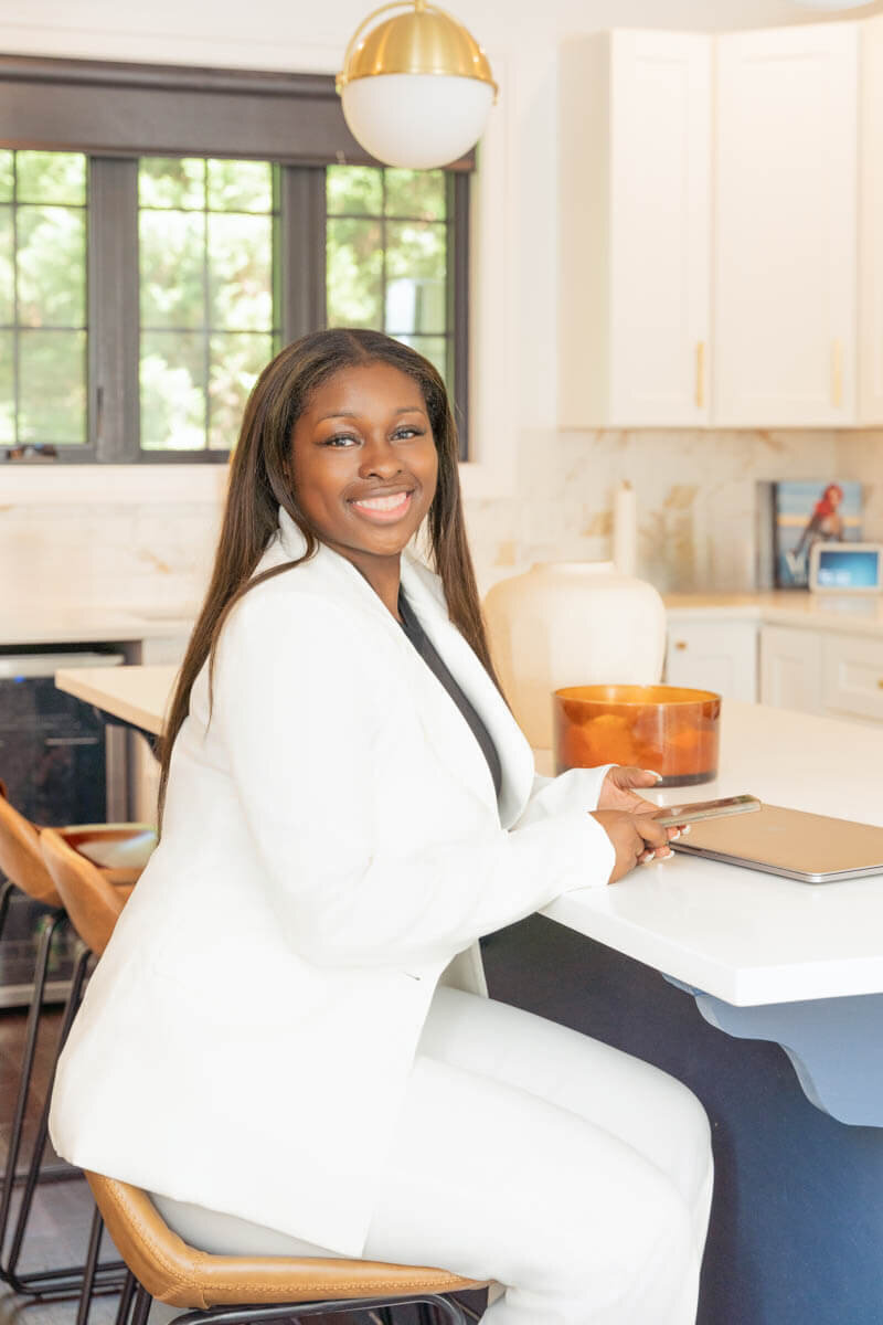 real estate agent  is in a kitchen posing for for brand photoshoot