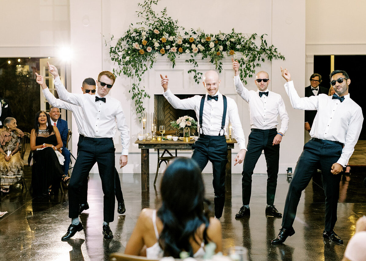 Groomsmen dancing for the bride at a wedding