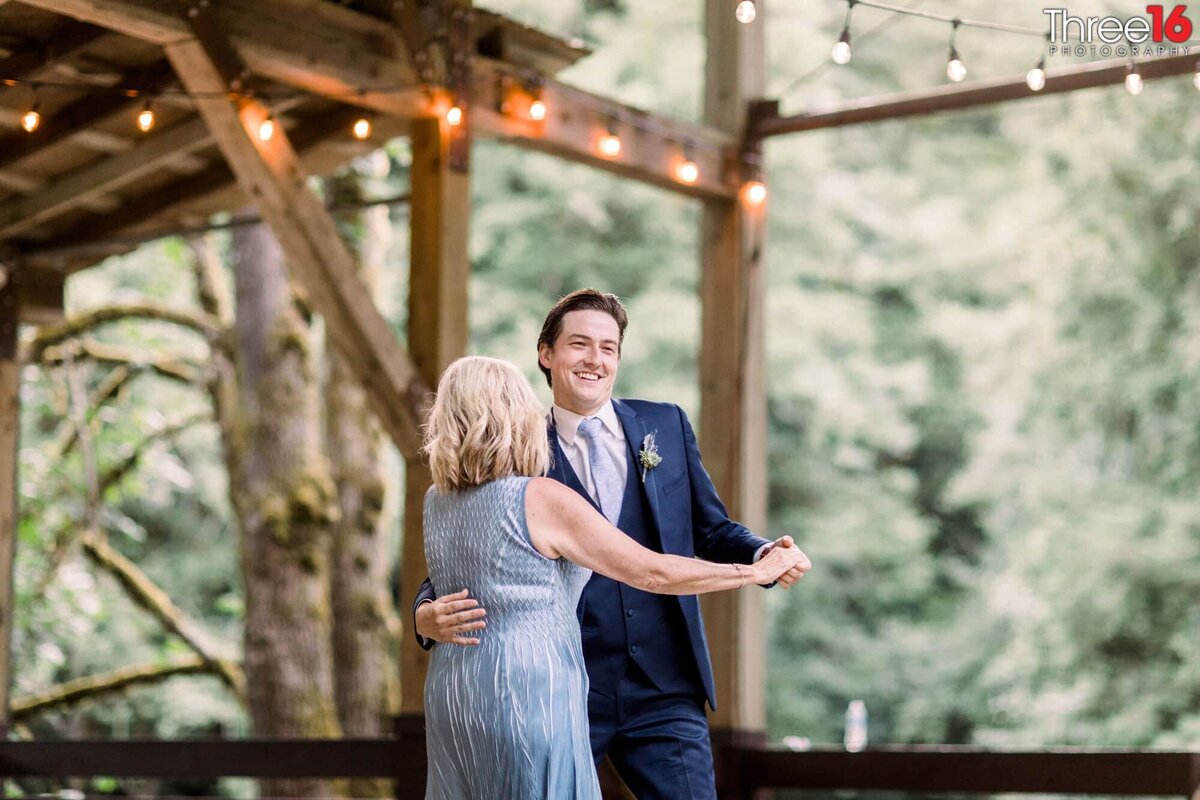 Groom dances with his mom during his wedding reception