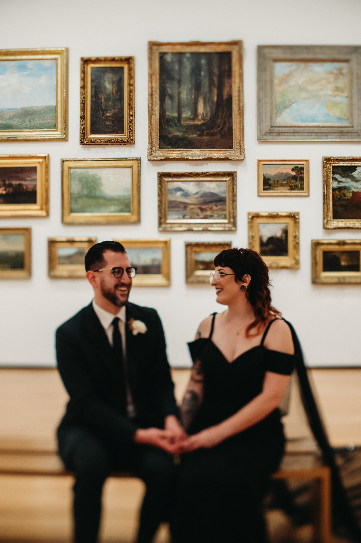 Tilt shift portrait of laughing couple in museum photo by Paige Mireles