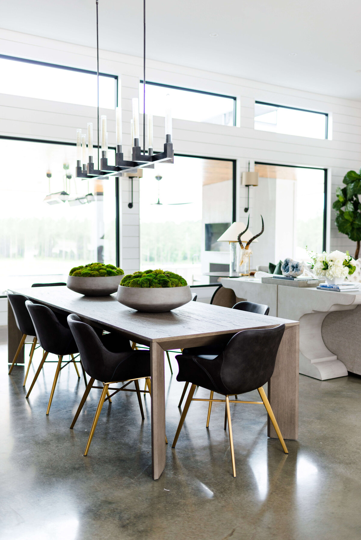 oyster creek studios building belt new build black chairs around a dining room table overlooking kitchen