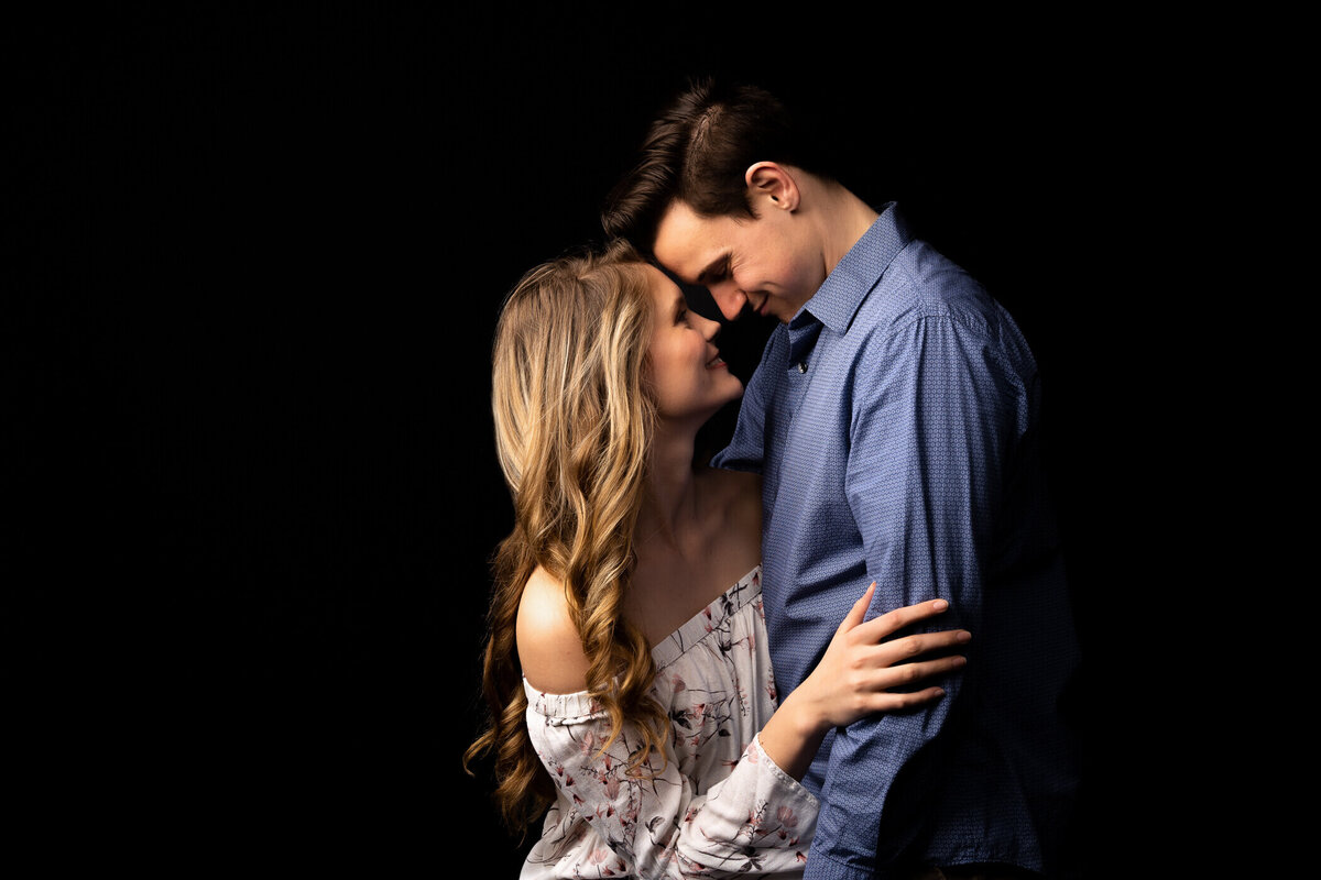 Michael and Deidra holding one another in a studio portrait
