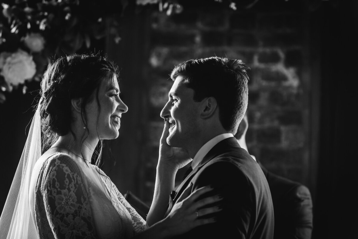 Bride and groom embrace during wedding ceremony