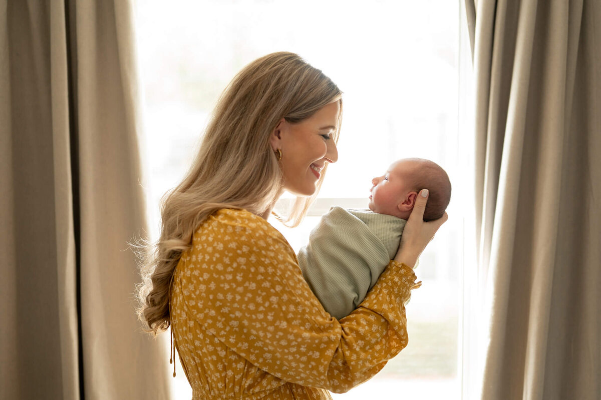 Mom holding baby and looking at her