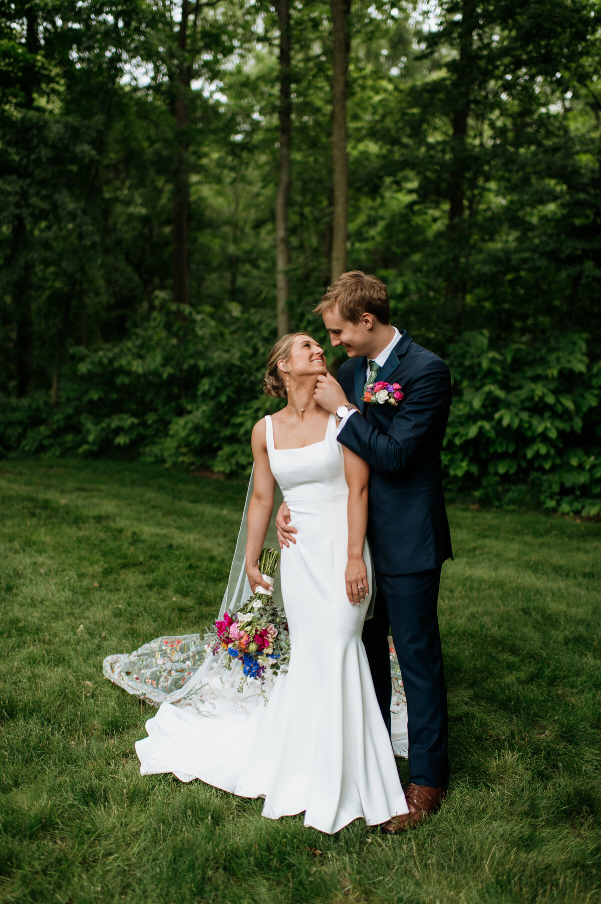 Bride and groom smiling outdoor wedding portrait