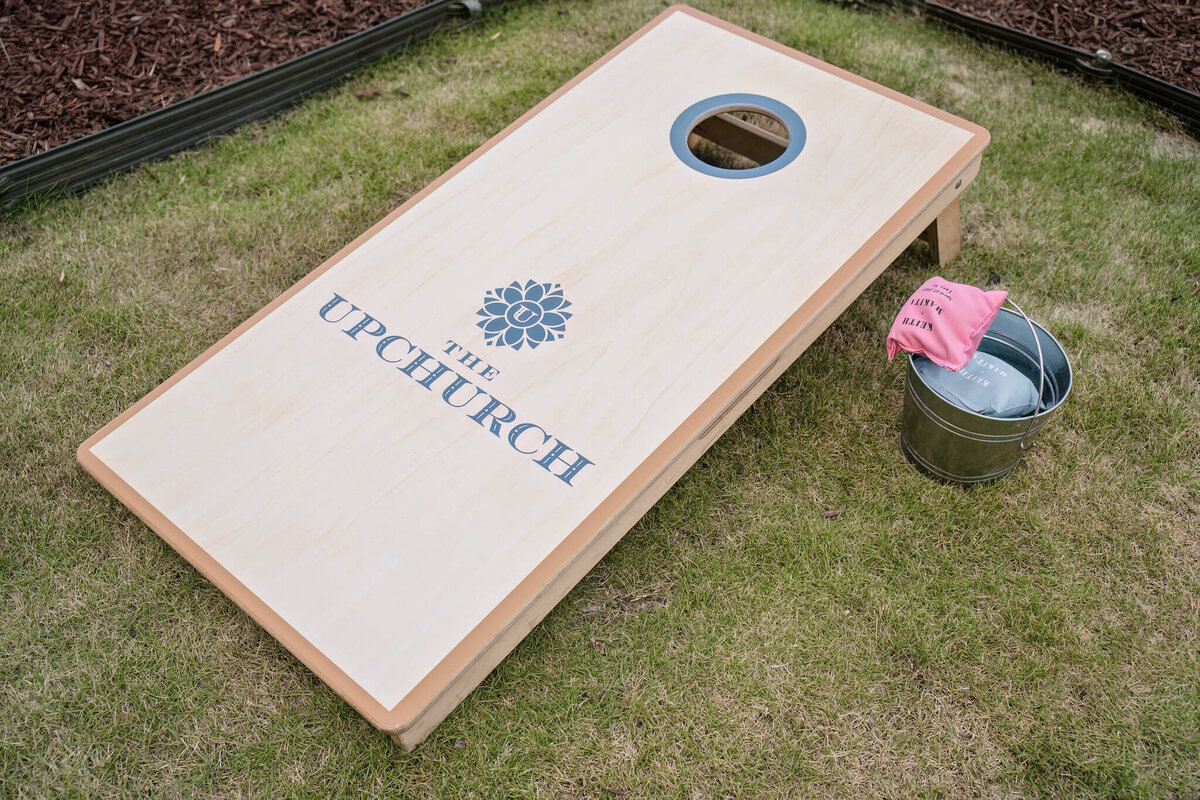 Personalized cornhole game board for a fun and unique wedding reception activity.
