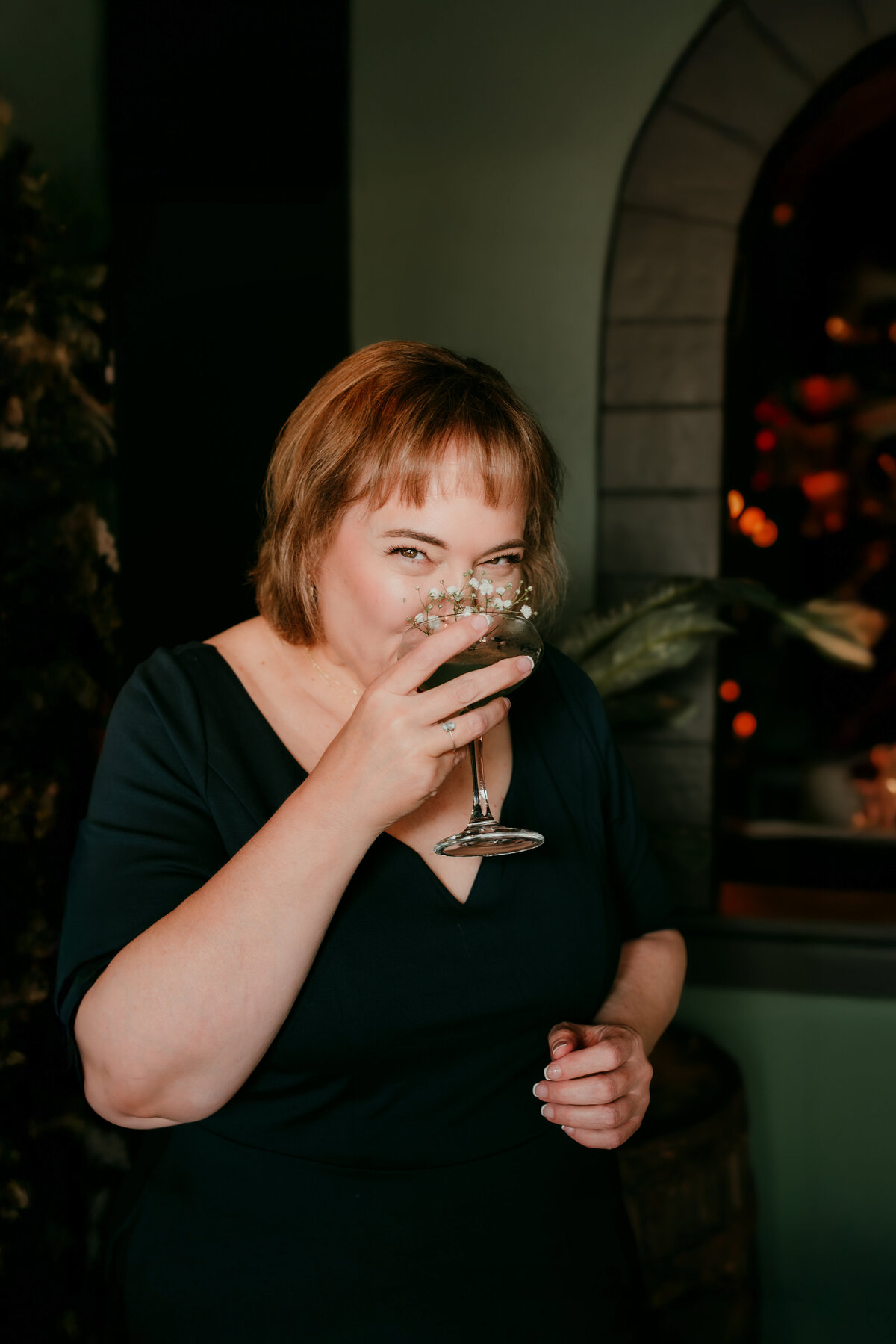 Modern and playful portrait of woman seated in vintage cocktail lounge in Minneapolis