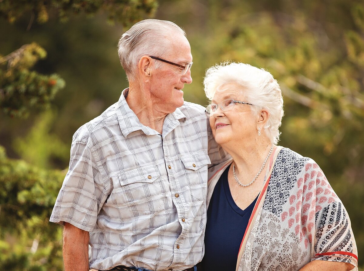 Older couple looking at each other with love in a forest